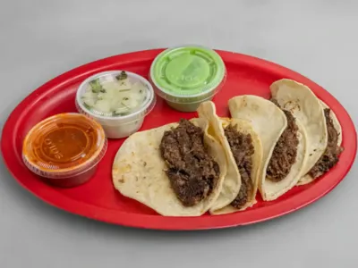 Tacos de Barbacoa from Lonches Sota, slow-cooked beef in tortillas.