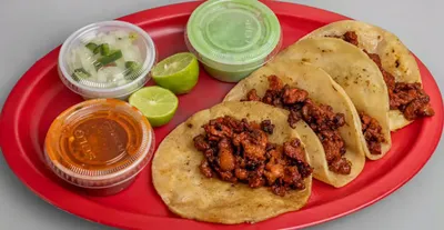 Tacos al Pastor from Lonches Sota, featuring marinated pork on small tortillas.