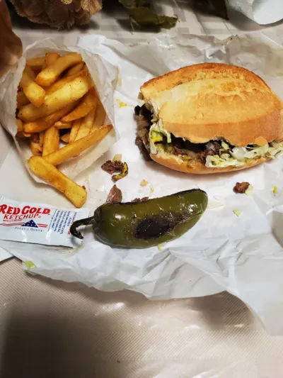 Torta de Bistec with Fries from Lonches Sota, a steak sandwich served with a side of french fries.